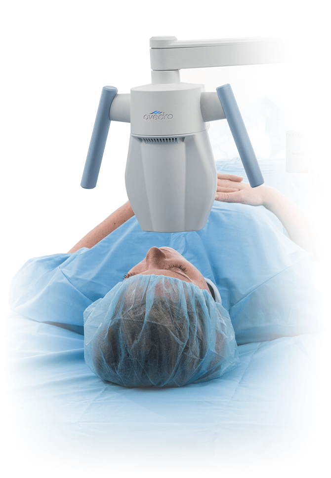 Patient laying below the KXL® system for performing cross-linking and Lasik Xtra®.