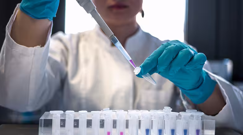 Lab technician adding liquid to an Eppendorf Tube